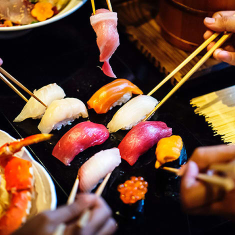 A group of friends sharing sushi.