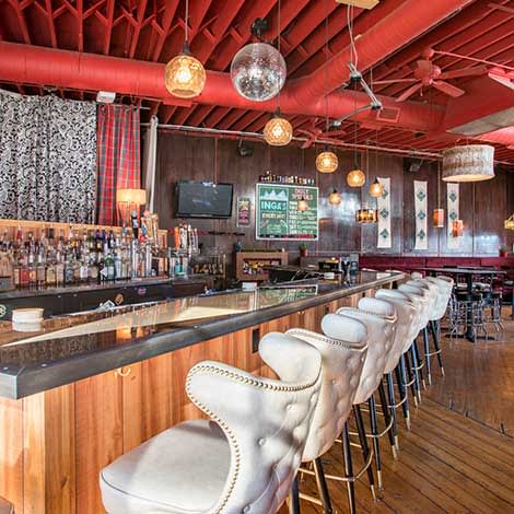A country modern styled bar with a red ceiling.
