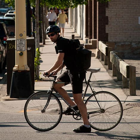 A man waiting at a stoplight on his bike.