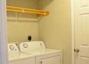 Thumbnail 14 of 22 - In-unit laundry room with full-size washer and dryer and hanging rack