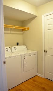 Thumbnail 14 of 22 - In-unit laundry room with full-size washer and dryer and hanging rack