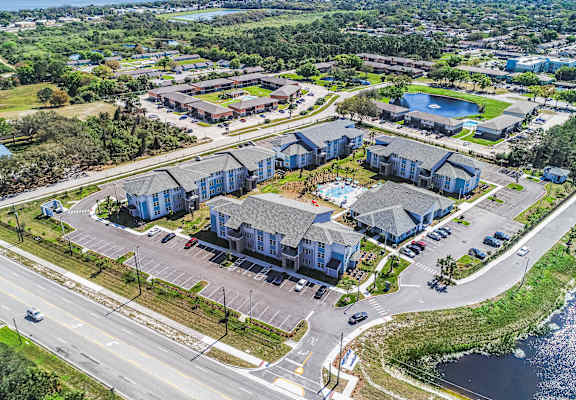 A bird's eye view of a residential area with a large building in the center.