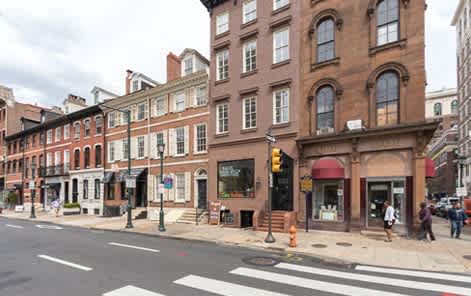 A street scene with a crosswalk and a traffic light.
