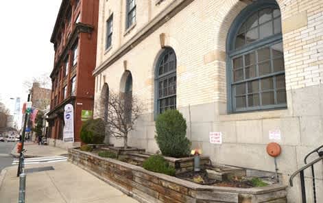 A brick building with a planter box in front of it.