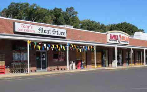 A storefront with a sign that says "Tony's Outfitters" and "Family Owned.".
