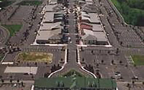 A large parking lot with a green strip in the middle.