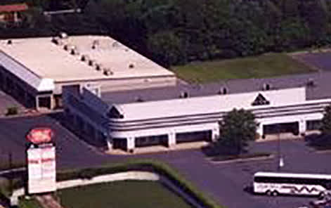 A large building with a parking lot in front.