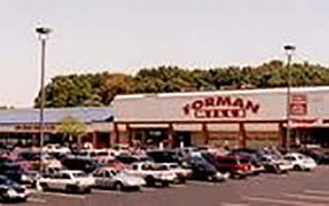 A parking lot in front of a store with a sign that says "German".