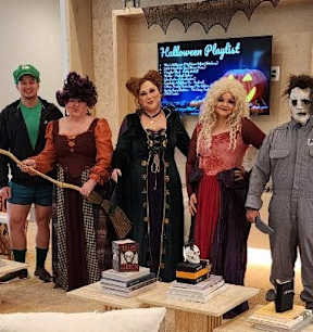 a group of people in costumes standing in a room