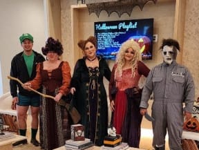 a group of people in costumes standing in a room
