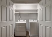Thumbnail 7 of 26 - A laundry room with a washer and dryer.