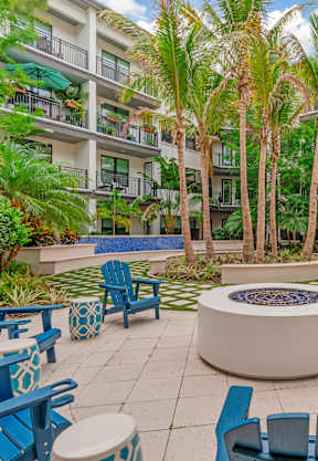 a coffee table with a vase of flowers on it at The District at Rosemary, Florida, 34236