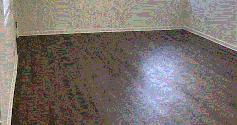 a bedroom with hardwood floors and a window
