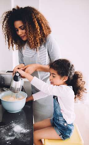 Woman cooking with her daughter at The Graham at Southern Towers, Alexandria, 22311