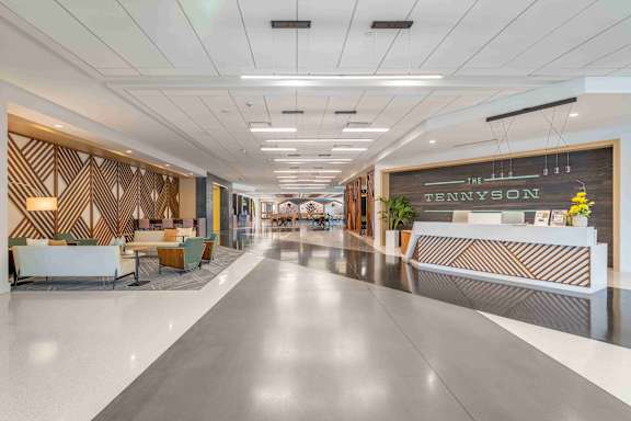 A long hallway with a reception desk at the end.