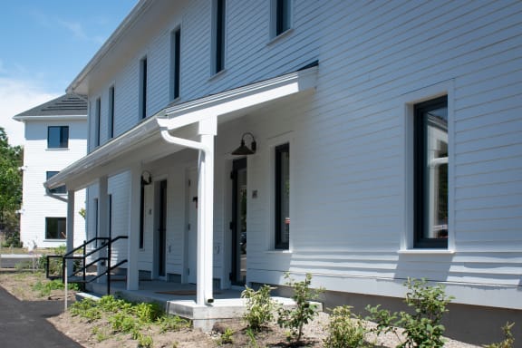 a view of the front porch of a white house