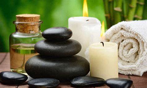 a stack of rocks and candles on a table