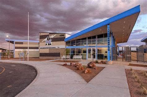 a large building with a blue roof and a street in front of it