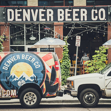 A branded van in front of Denver Beer Co.'s patio.
