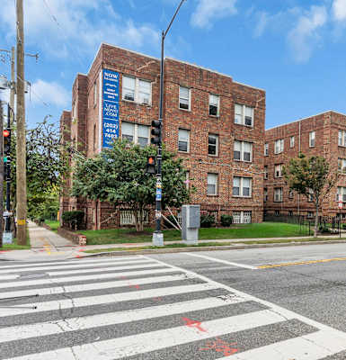 A street view of a crosswalk with a red star on it.