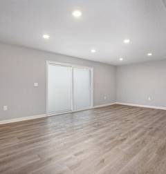 A room with wooden flooring and a bar counter.at Palisades Apartments, Kansas City