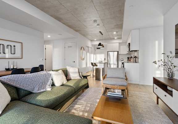a living room with green couches and a coffee table