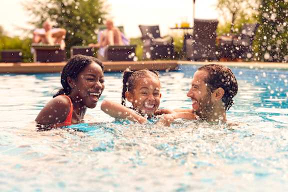 a woman and a child in a pool