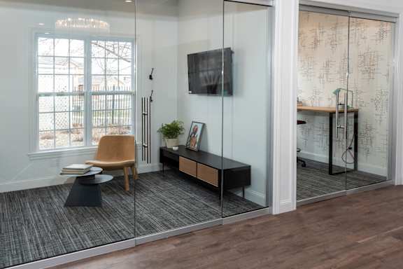 A room with a wooden floor and a glass wall.