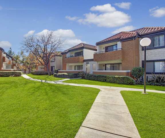 The exterior of Castlepark Apartments showing pathways through grass. 