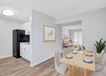 A dining room with a wooden table set for six.