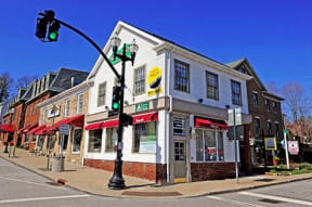 a street corner with a traffic light and a white building