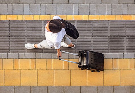 a man is pulling a suitcase on a rope