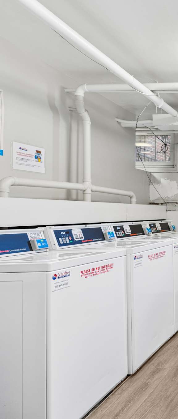 A laundry room with washers and dryers.
