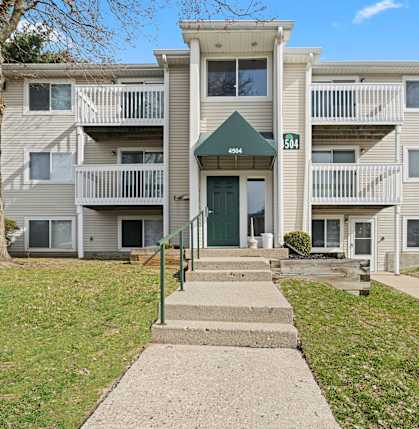 Apartment building with a green awning and a sign that says 504.