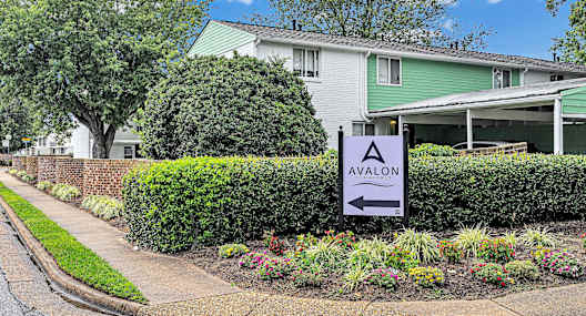 A sign in front of a building that says Avalon.