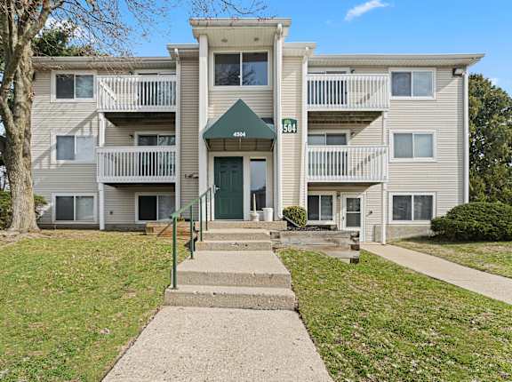 Apartment building with a green awning and a sign that says 504.