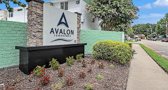 Avalon Townhomes sign in front of a building.