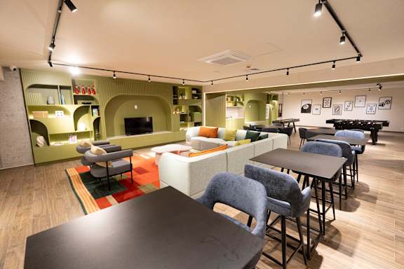 A room with a long table and chairs.