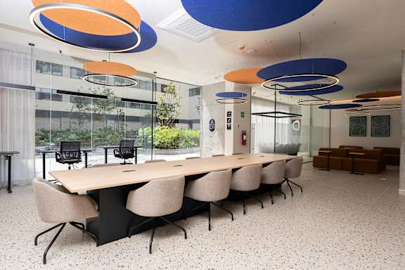 A conference room with a long table and chairs.
