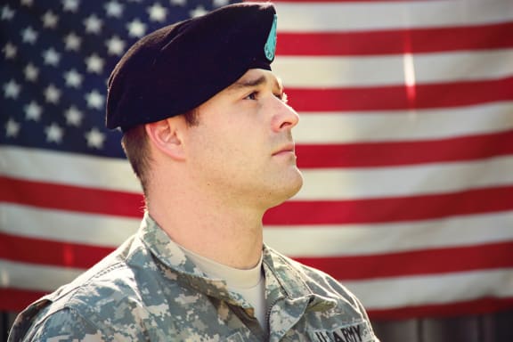 soldier in front of American flag at Legends at Rancho Belago, California, 92553