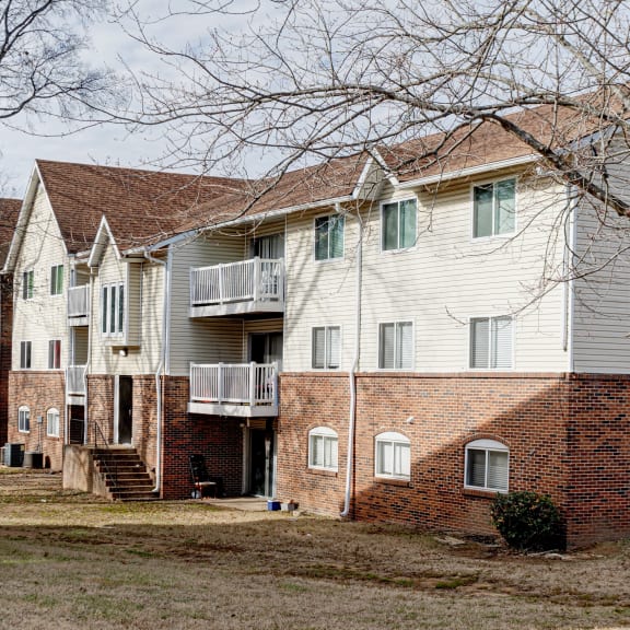 a row of brick and white houses on a street at The Grove Brentwood in Nashville, TN