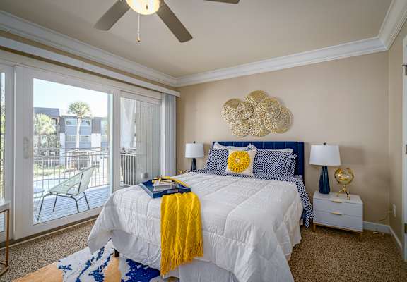 a bedroom with a large bed and a ceiling fan