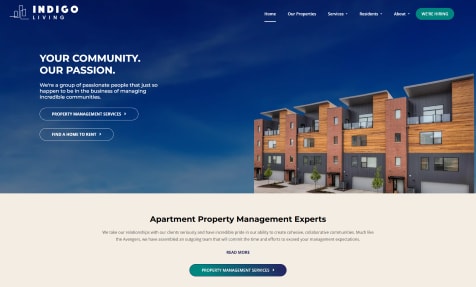 A screenshot of a webpage with a blue and white color scheme, featuring images of buildings and a person holding a tablet.