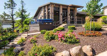 A modern house with a garden in front.