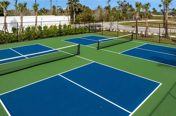 A tennis court with blue and green colors.