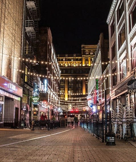 a city street at night with street lights at East 4th Street, Cleveland, 44115