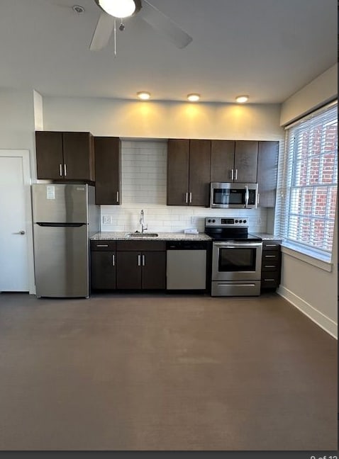 A kitchen with brown cabinets and stainless steel appliances.