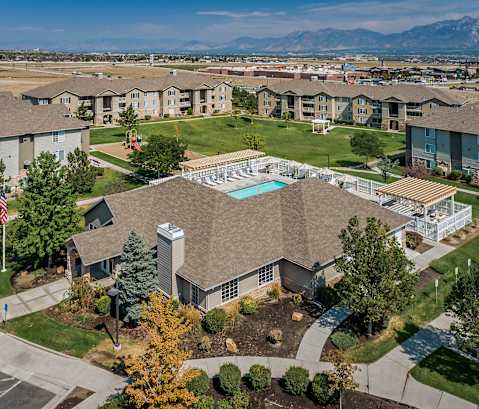 A large apartment complex with a swimming pool in the center.