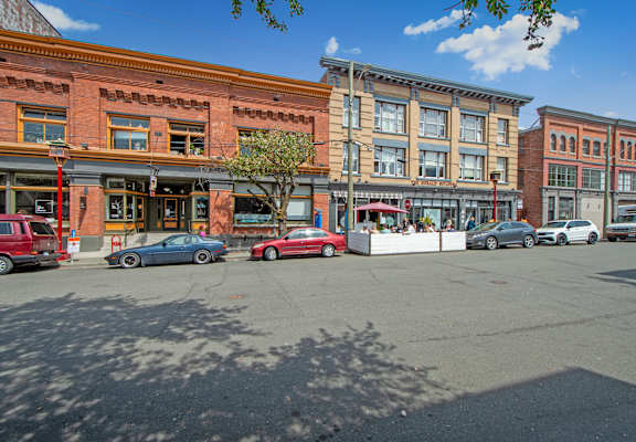 A street view with cars and buildings.