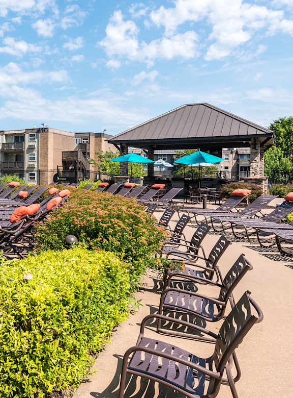 Pool surround by black lounge chairs at The Falls, Mission Kansas